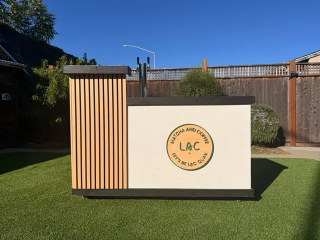 Lạc Coffee's on-tap cart, wood-slat paneling and dual nitro taps, with the Lạc medallion on the front panel