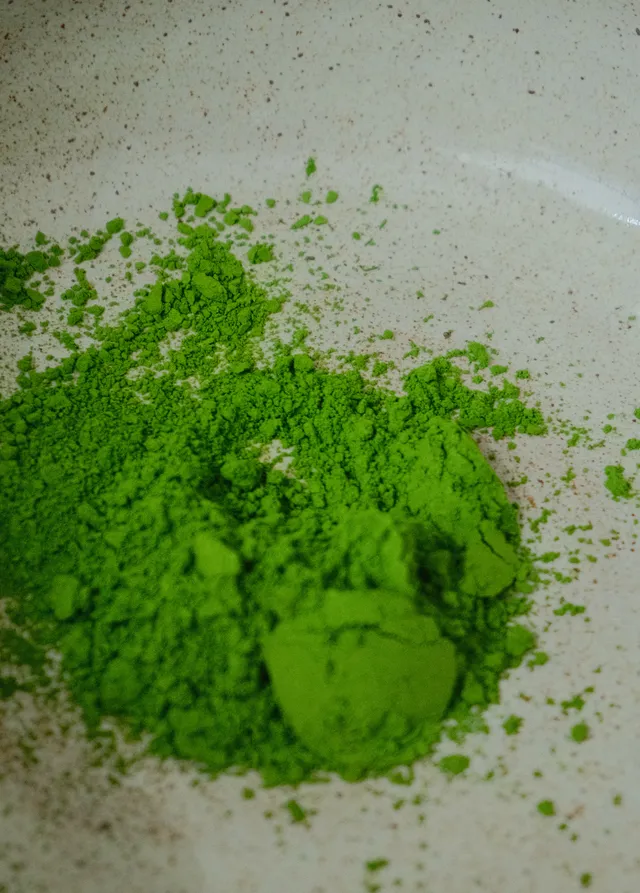 Close-up of vivid green ceremonial matcha powder mounded on a plate